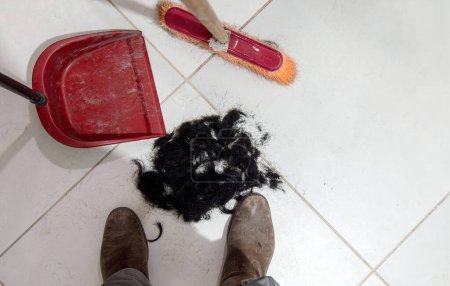 A Sweeping hair off the floor after haircut
