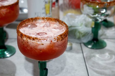 A Cold michelada cocktail with clamato, chili and lemon, with space for text