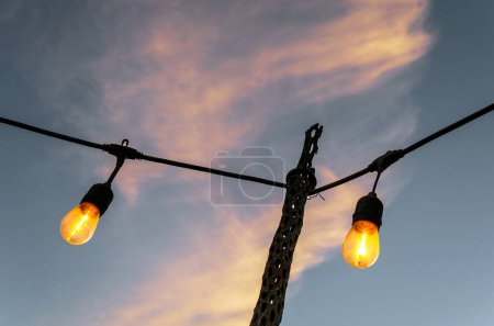 A Vintage old light bulbs with sky background at sunset