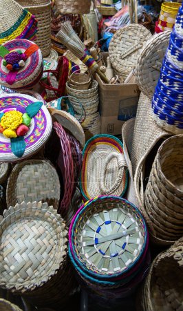 A Baskets and hats made of palm leaves woven in Mexico, with space for text
