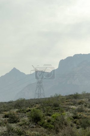 A Power lines in a field with mountains