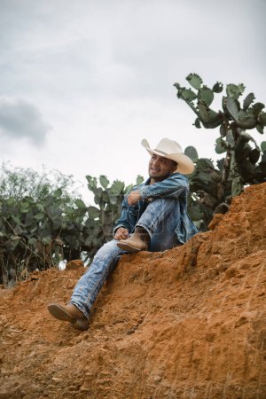 A cowboy under the vast sky, surrounded by cacti, working on a farm