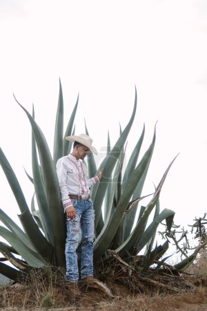 A Mexican cowboy, agave plants, nature beauty, sunglasses, toddler, captivating landscape