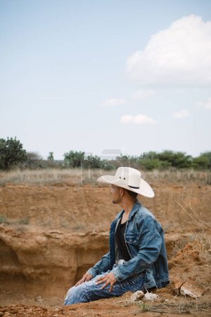 A Cowboy under the vast sky, surrounded by cacti, working on a farm