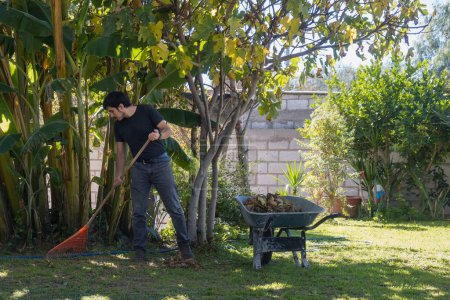 A Man sweeping garden lawn in elegant home