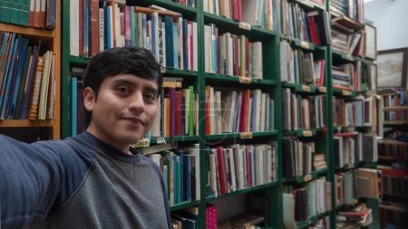 A Young man in library holding secondhand books, with space for text