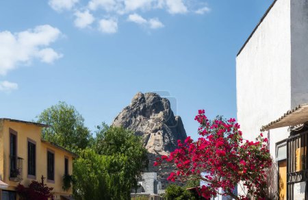 A Mexican Magic Town with old houses and pink flowers, Bernal Peak, Monolith in Queretaro, Mexico.