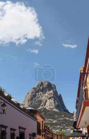 Photo for A Bernal Peak, Monolith in Queretaro, Mexico, buildings, and the mountain in the background, with space for text at the top. - Royalty Free Image