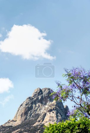 A Bernal Magical Town in Queretaro, Mexico, Monolith or Rock, with Purple Jacaranda Flowers, with space for text above