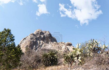 A Bernal Peak, Monolith in Queretaro, Mexico, with a blue sky.