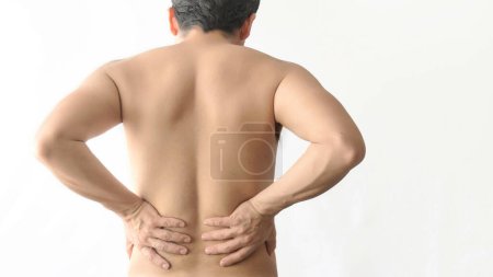 Photo for A Kidney pain. Holding lower back with hands. Man with back pain. Shirtless body. Man body pain on a white background with space for text. - Royalty Free Image
