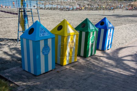 Foto de Waste bins for separating waste into 4 different containers, of different colors, on a beach on the island of Tenerife, Costa Adeje, Spain - Imagen libre de derechos