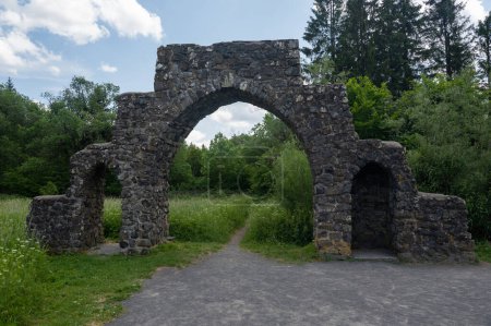 Entrance to the former Reich Labor Service camp, a gate made of basalt stones, relic of the Nazi era in the Rhoen at the  black  Moor, Germany