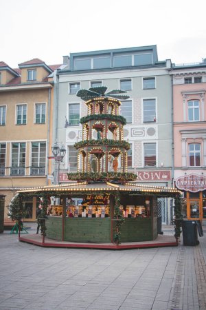 Photo for 3.12. 2022 - Gliwice, Poland. Wooden decorated and Christmas stall offering drinks to warm up in the cold December weather on the corner of the main square. - Royalty Free Image