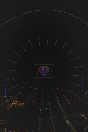 Photo for 3.12. 2022 - Katowice, Poland. A Christmas rainbow heart in the middle of a ferris wheel at the Christmas market during Advent on the main square Rynek, Katowice. - Royalty Free Image