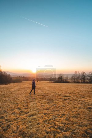 Photo for Adventurer in winter jacket enjoys the last touches of the sun. Sunset over stress-relief guy from work and get back positivity. Beskydy mountains, Czech republic. - Royalty Free Image