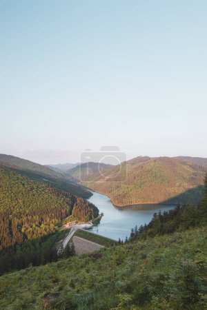 Photo for Sunset over the Sance dam near Ostravice in the middle of Beskydy mountains. View of the dam set in a hilly and forested environment. Drinking water reservoir. - Royalty Free Image