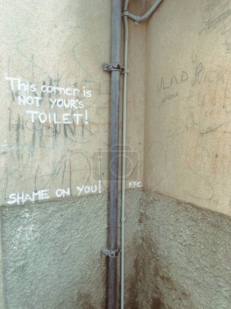 Photo for Urinal corner of the alleyway sign asking people not to use the toilet in public places. High quality photo - Royalty Free Image