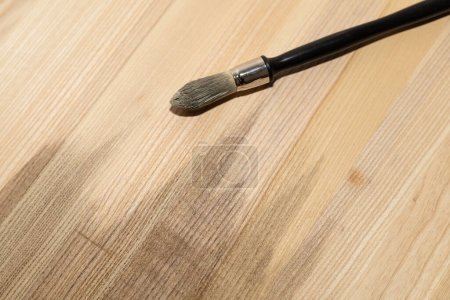 covering with a brush colored oil of a wooden ash shield