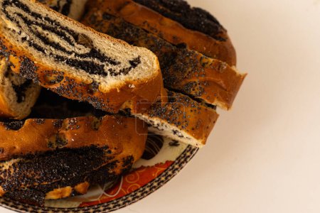 pieces of roll with poppy seeds on a plate