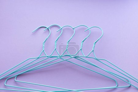 Photo for Hangers for clothes on purple background - Royalty Free Image