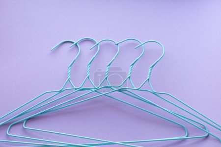 Photo for Hangers for clothes on purple background - Royalty Free Image