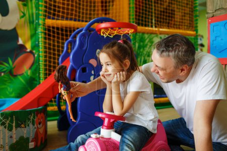 Photo for Father and daughter have fun and play in the children's creative center. - Royalty Free Image