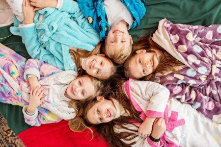 Photo for Merry Christmas and Happy Holidays. Group of children having fun at pajama party. Cozy home - Royalty Free Image