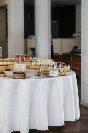 Photo for Candy bar. Table with sweets, candies, and dessert. Wedding event. - Royalty Free Image