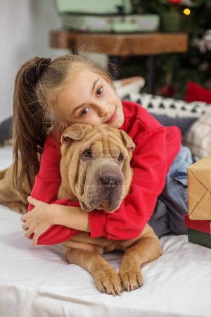 Photo for Boxing Day. Shar Pei dog. Merry Christmas and Happy Holidays. Child girl and dog at Christmas. - Royalty Free Image