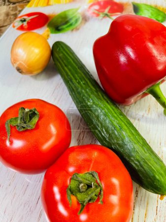 Photo for Vegetables, salad, vitamins, kitchen, table, board, cook, health, vegan, pepper, tomato, cucumber, onion, food, eat, colors, red, green - Royalty Free Image