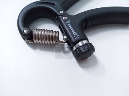 Close up Black Adjustable Hand Grip Strengthener Isolated On White Background. Hand exercise gripper for Athletes and Hand Rehabilitation Exercising
