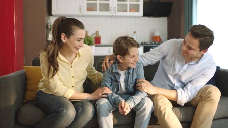 Photo for Portrait of parents who care about their children.Young couple spending time with their little son in the living room of their house. Happy smiling family portrait. - Royalty Free Image