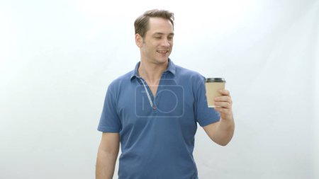 Photo for Studio portrait of young man holding paper coffee mug. Smiling positive man holding paper cup on white background looking at empty advertising space. - Royalty Free Image