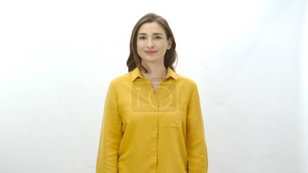 Photo for Woman smiling looking at camera isolated on white background.Portrait of beautiful woman in yellow shirt. - Royalty Free Image