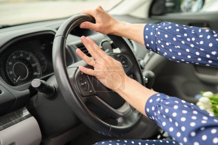 Photo for Woman driver hand honking her car horn to prevent accident. Driving safety concept. - Royalty Free Image
