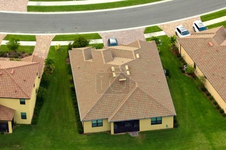 Aerial view of typical contemporary american private house with roof top covered with ceramic shingles and double garage.