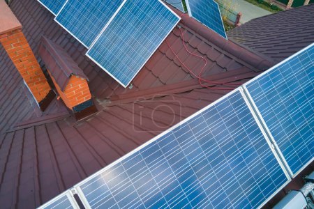 Photo for Aerial view building roof with rows of blue solar photovoltaic panels for producing clean ecological electric energy. Renewable electricity with zero emission concept. - Royalty Free Image