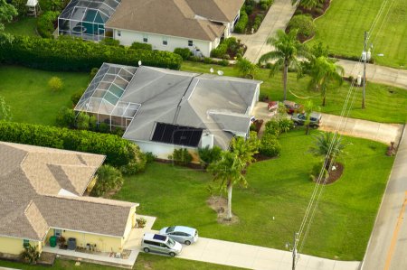 Photo for Aerial view of small town America suburban landscape with private homes between green palm trees in Florida quiet residential area. - Royalty Free Image