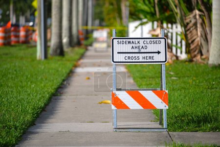 Photo for Warning sign that sidewalk is closed at street construction site. Utility work ahead. - Royalty Free Image
