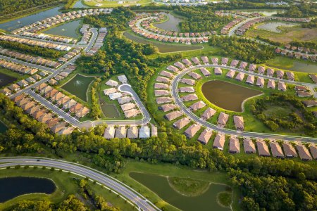 Photo for View from above of densely built residential houses in closed living clubs in south Florida. American dream homes as example of real estate development in US suburbs. - Royalty Free Image