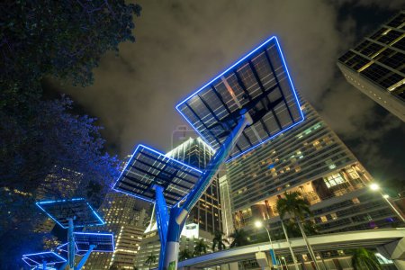 Downtown district of Miami city with photovoltaic panels mounted on metal poles for electricity supply of street illumination and surveillance cameras. Futuristic energy source in modern megapolis.