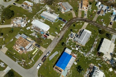 Aerial view of natural disaster consequences in Florida Southwest region. Severely damaged by hurricane Ian mobile homes in residential area.