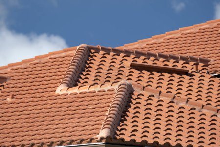 Tiled roof covering of condo building in Florida. Closeup of house rooftop covered with ceramic shingles.