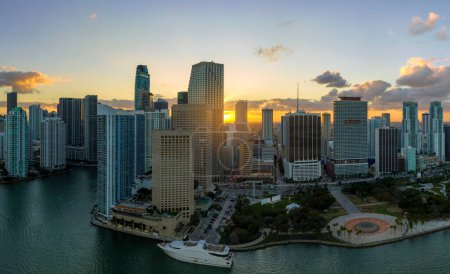 View from above of high skyscraper buildings in downtown district of Miami Brickell in Florida, USA at sunset. American megapolis with business financial district at nightfall.