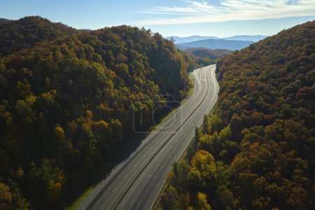 Photo for Aerial view of empty I-40 freeway in North Carolina leading to Asheville through Appalachian mountains in golden fall season. Interstate transportation concept. - Royalty Free Image