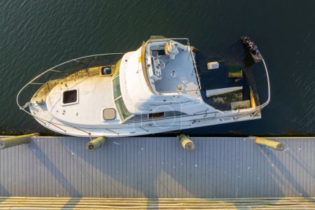 Half sunken sailing yacht capsized on shallow bay waters after hurricane Ian in Manasota, Florida.
