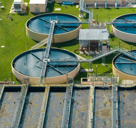 Photo for Aerial view of water treatment factory at city wastewater cleaning facility. Purification process of removing undesirable chemicals, suspended solids and gases from contaminated liquid. - Royalty Free Image