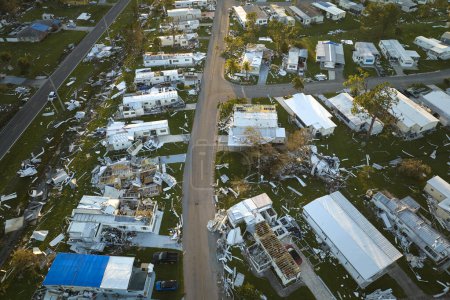 Severely damaged houses after hurricane Ian in Florida mobile home residential area. Consequences of natural disaster.