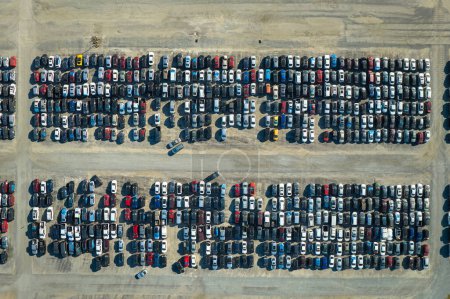 Used damaged cars on auction reseller company big parking lot ready for resale services. Sales of secondhand vehicles for rebuilt or salvage title.